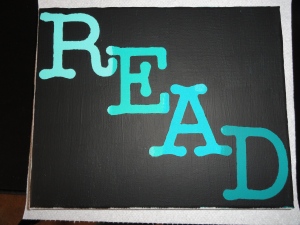 A small Canvas that says READ